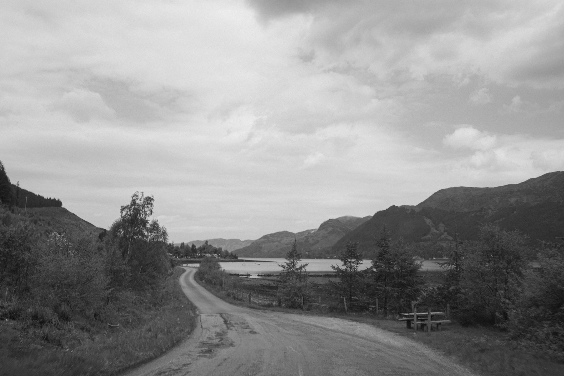 Single-track road winding down toward Loch Duich, hills either side