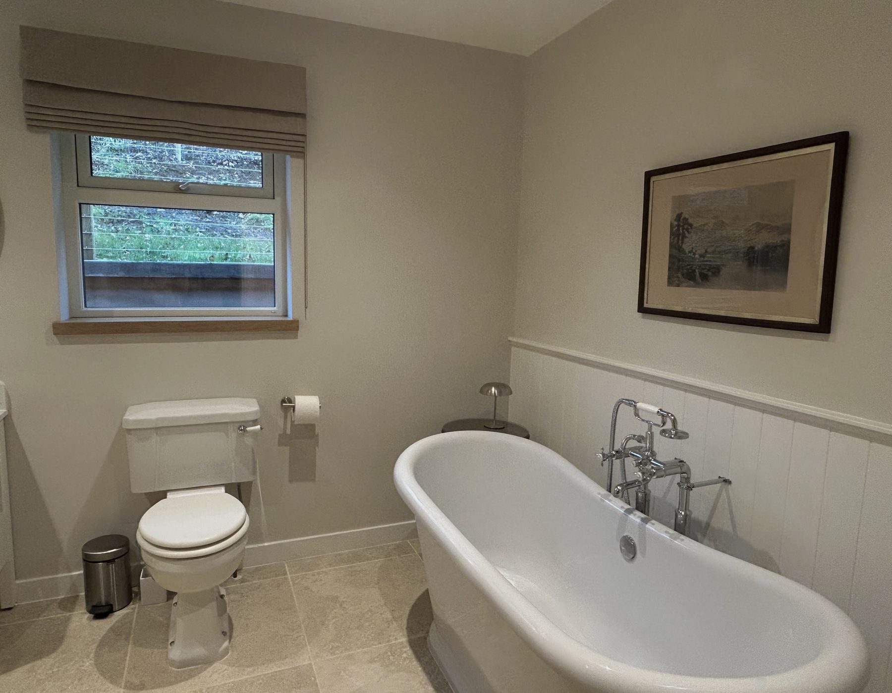 Shared bathroom with roll-top bath