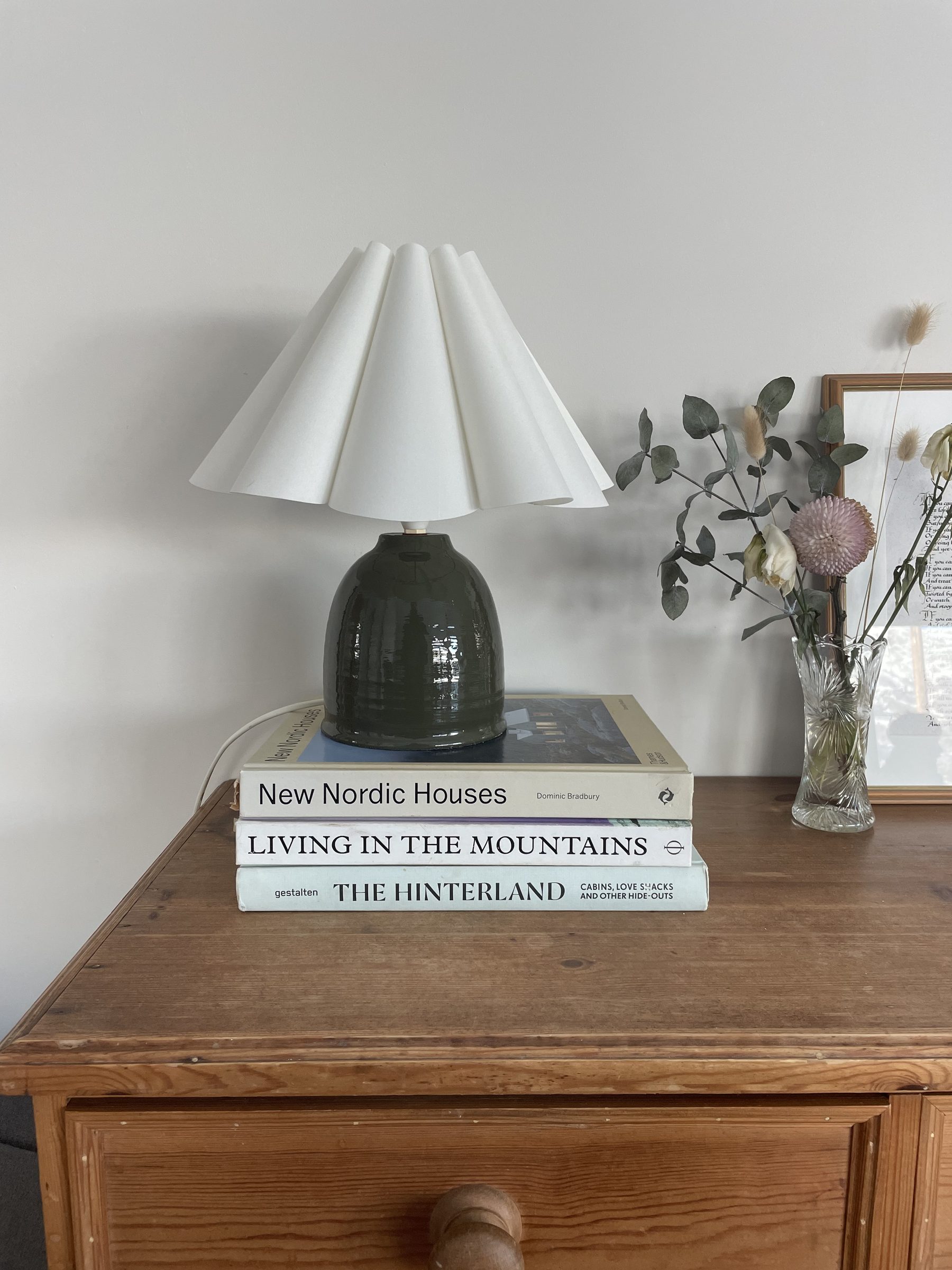 Bedside lamp and books — New Nordic Houses, Living in the Mountains