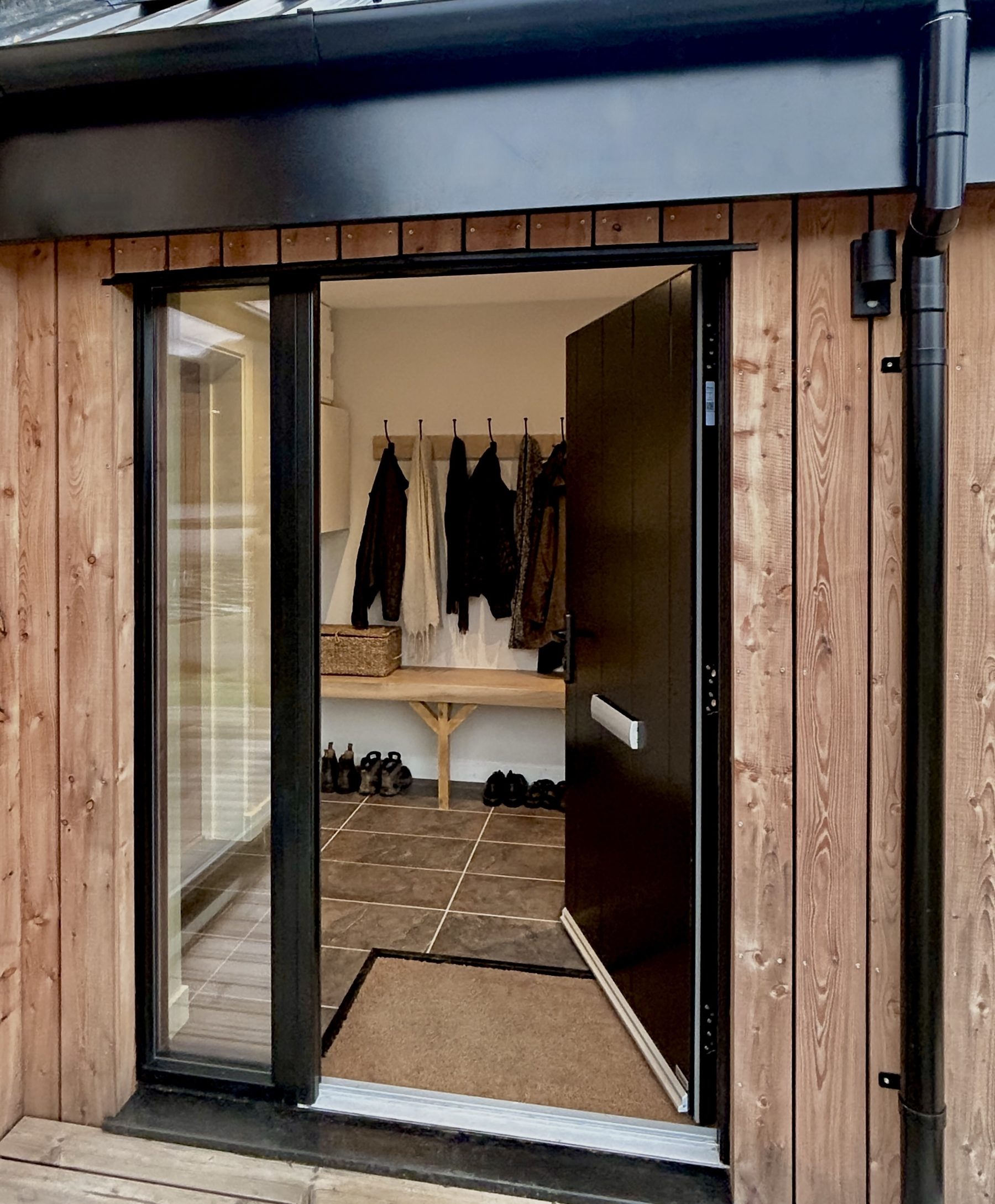 Cedar-clad entrance and boot room