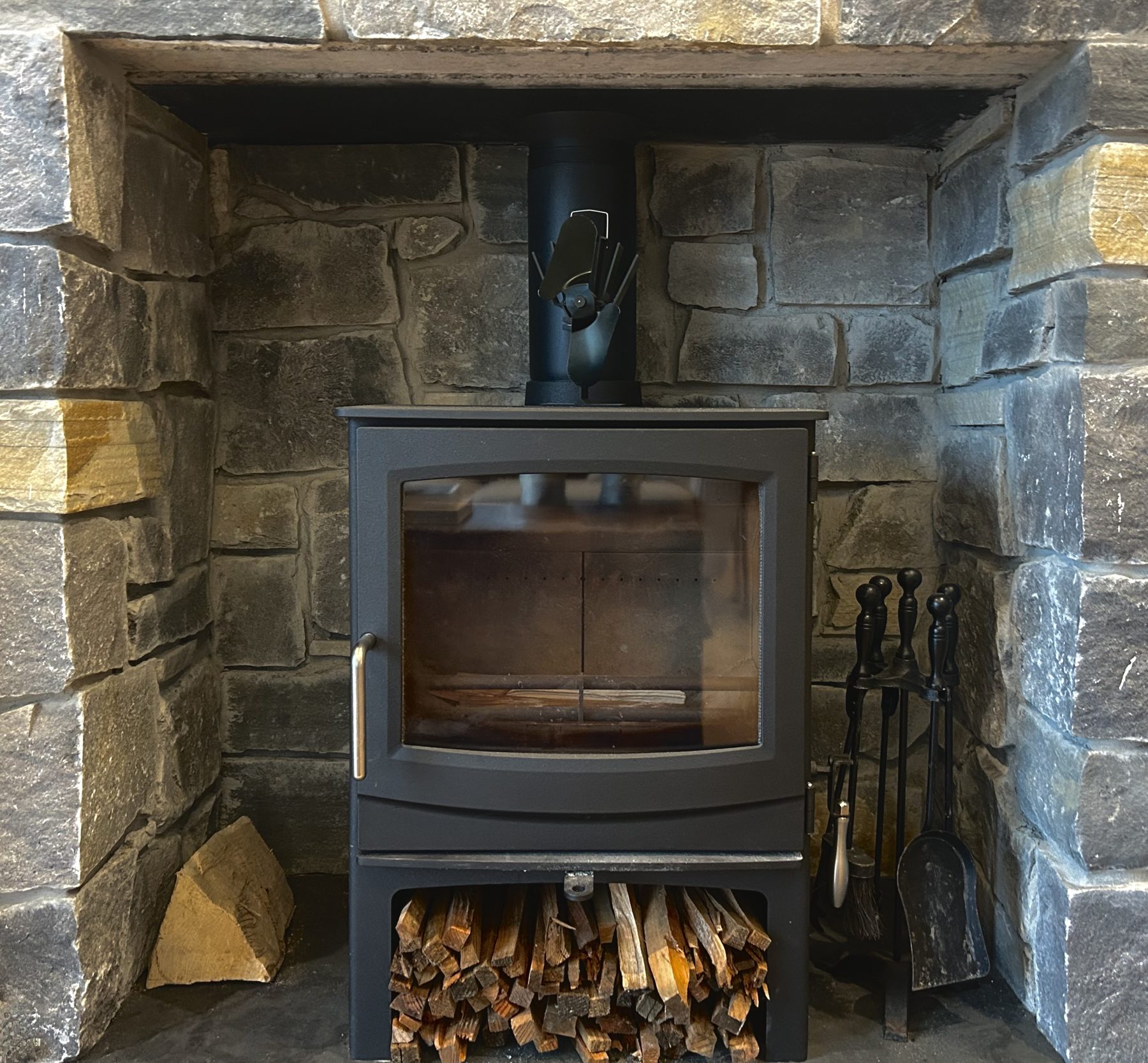 Wood-burning stove in stone surround